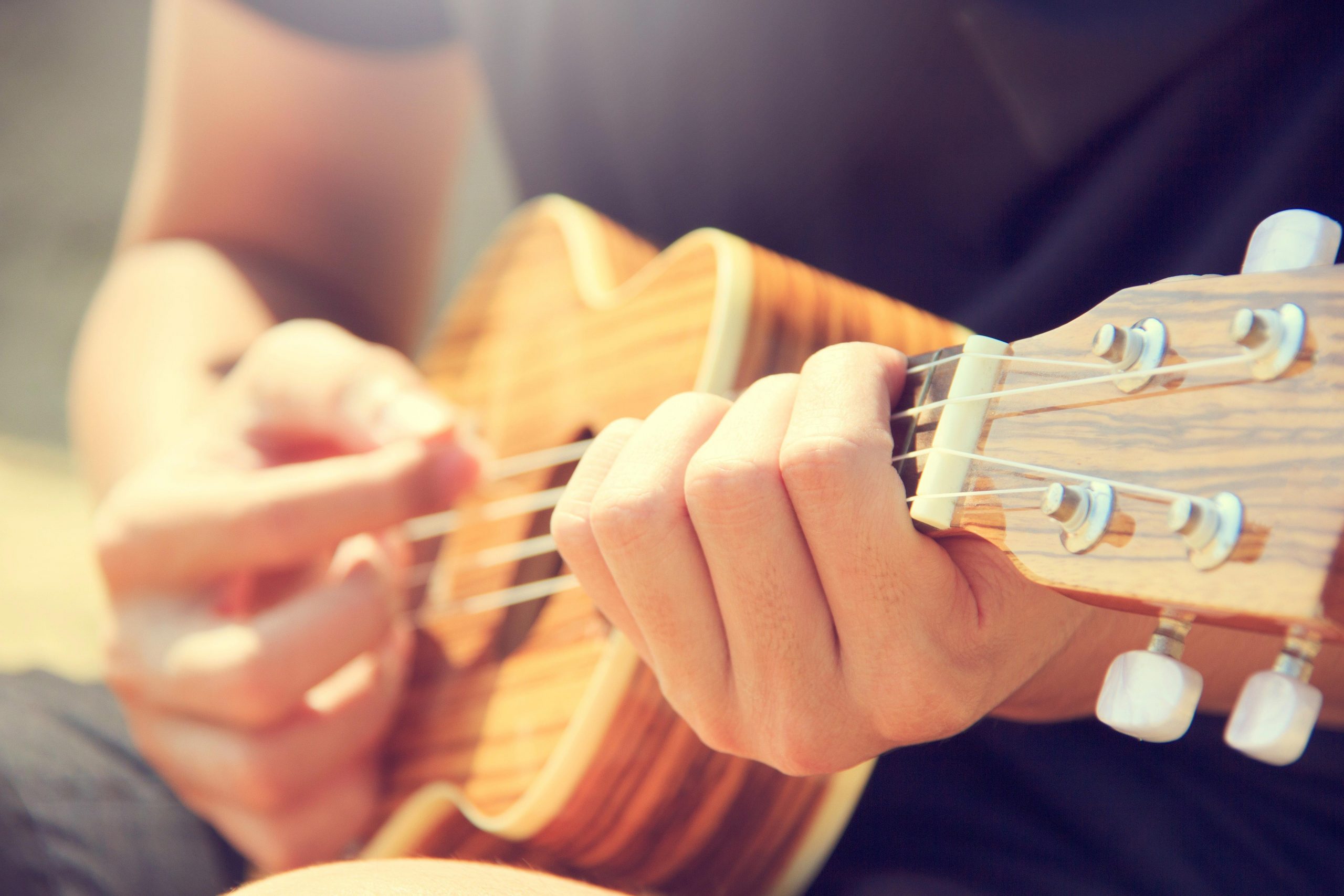 a boy playing Ukelele