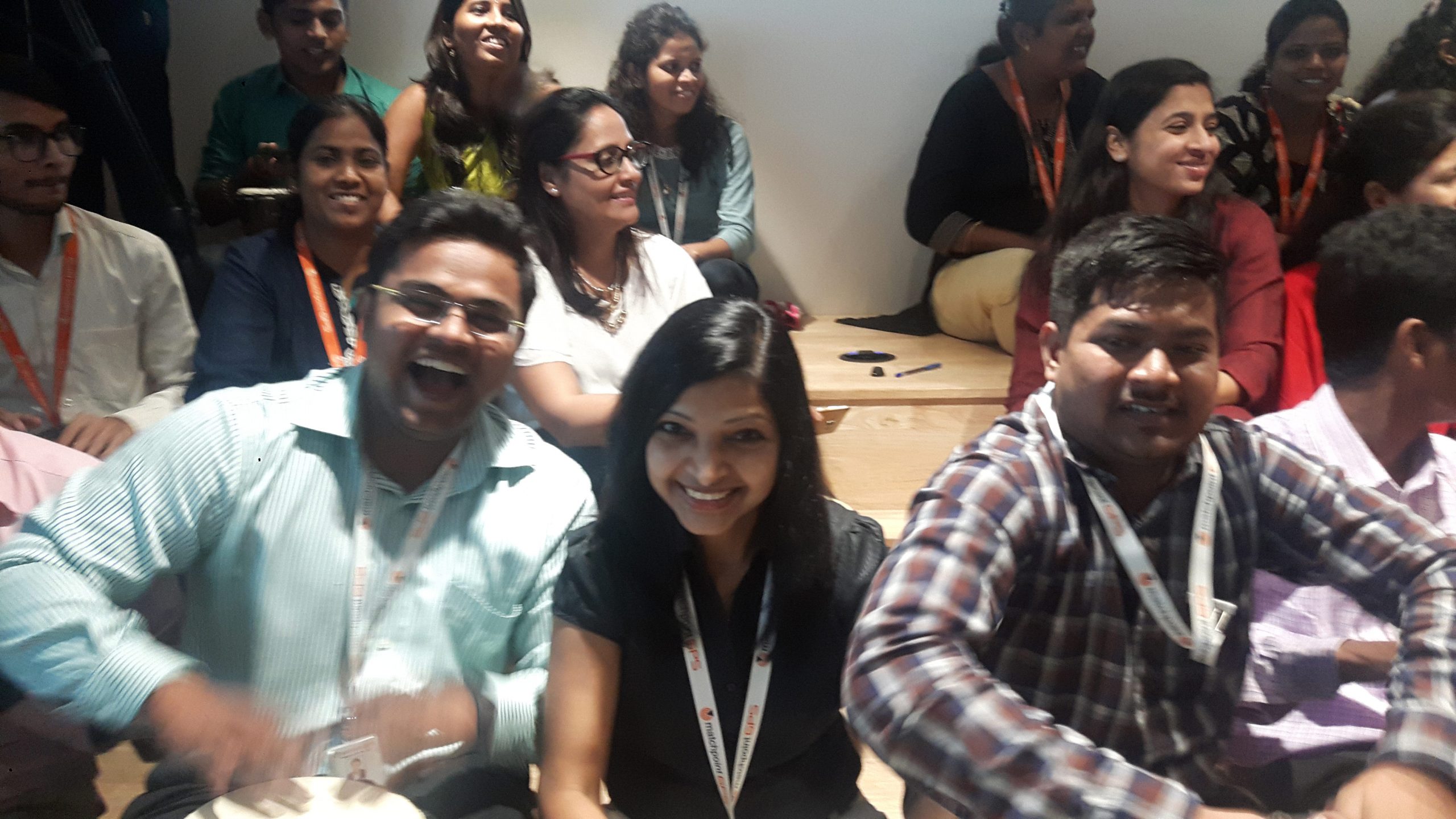 a group of people enjoying drum circle in an office